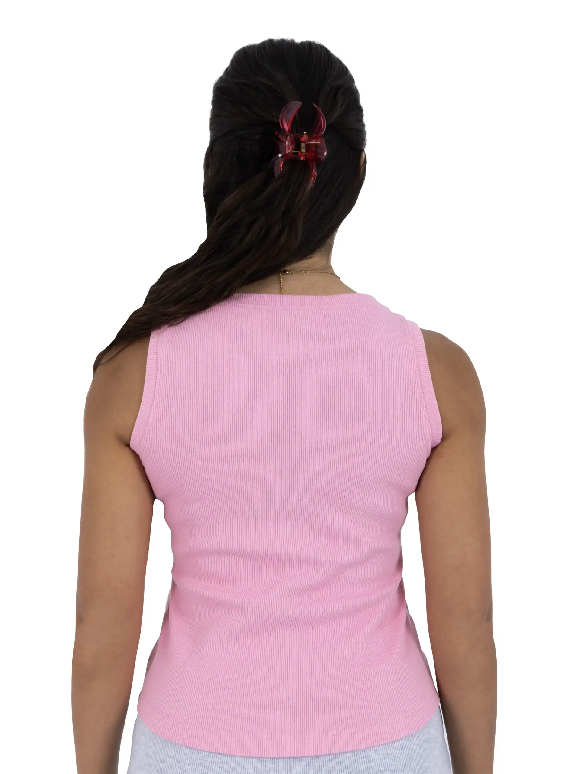 Back view of a woman wearing a pink sleeveless top with a red hair clip.